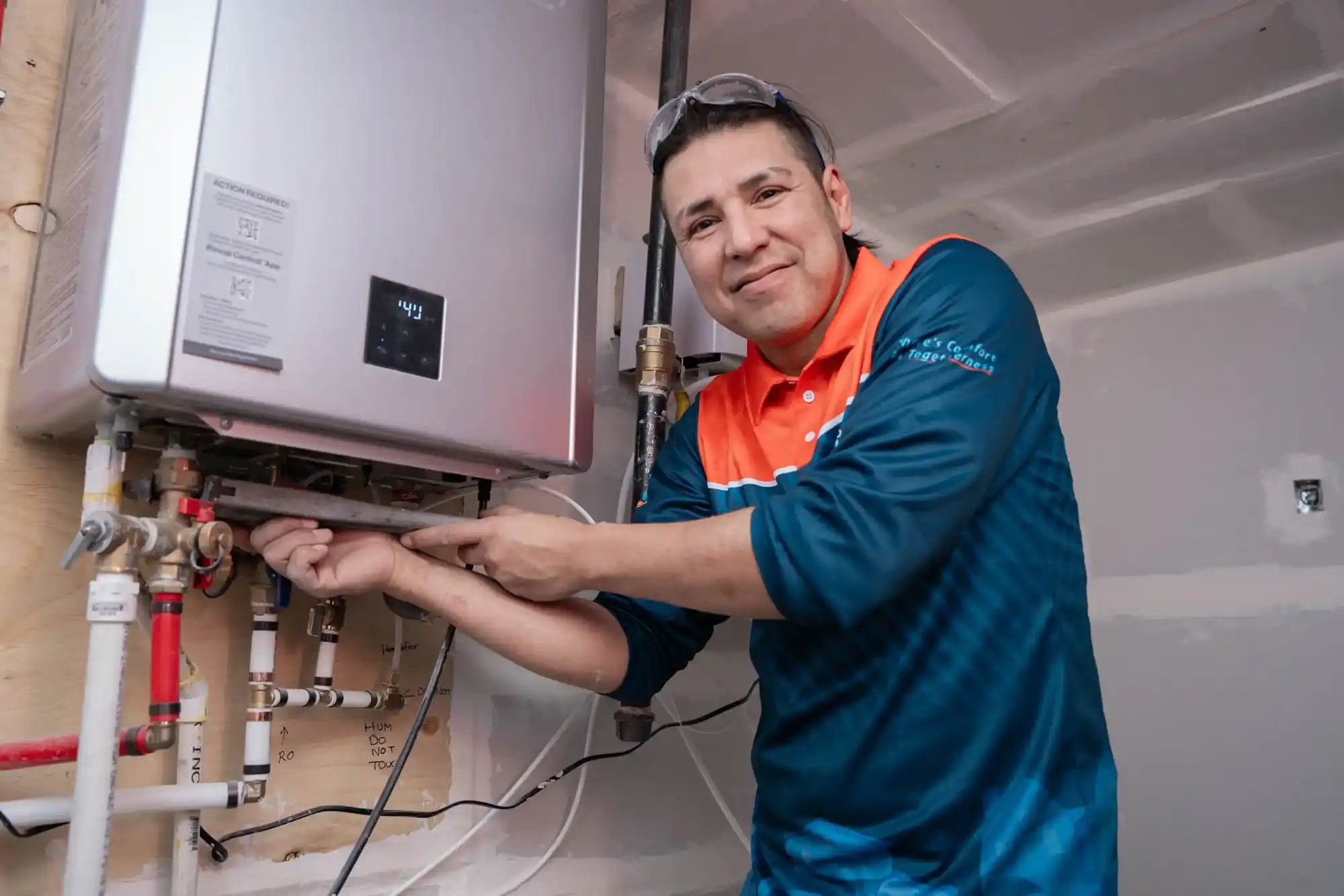 Comfort Union technicians installing water heater in Cochrane, Alberta