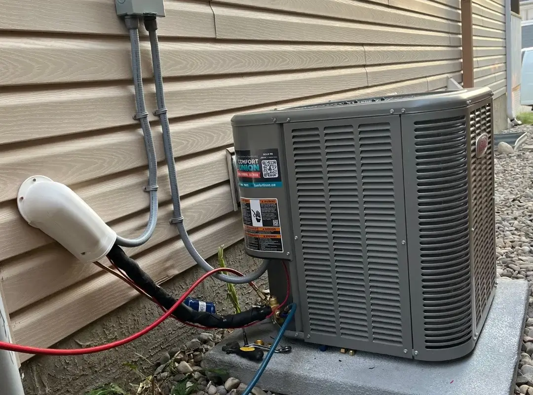 Finished installation of Lennox air conditioner at Cochrane residential home – side view with full wiring visible